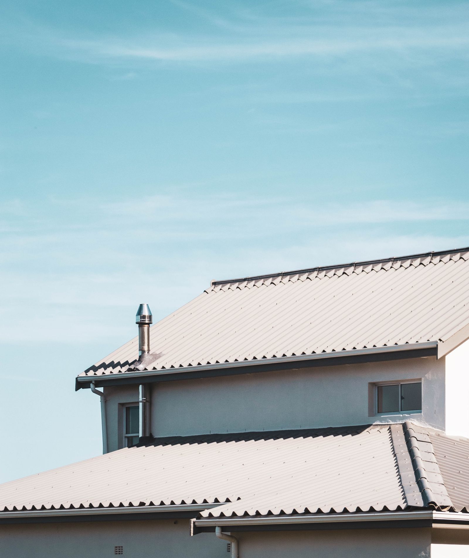 Residential roof under a clear sky